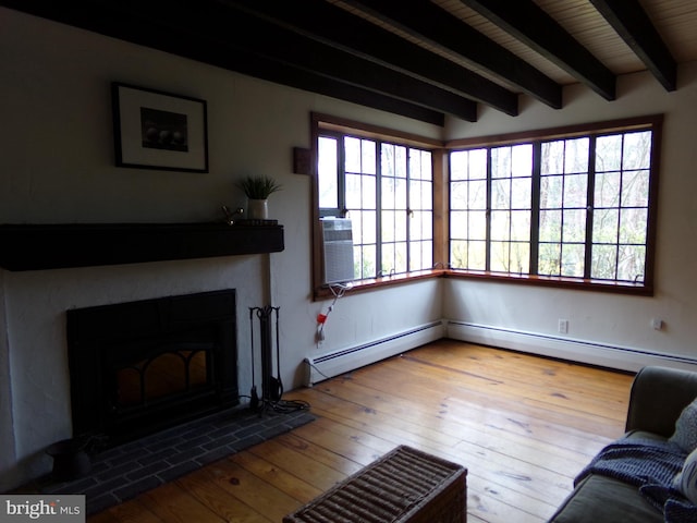 living room with beamed ceiling, wood-type flooring, and a baseboard heating unit