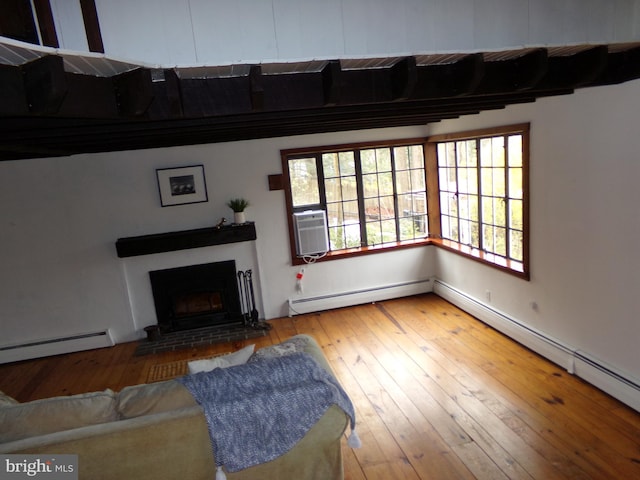 living room featuring hardwood / wood-style floors and a baseboard heating unit