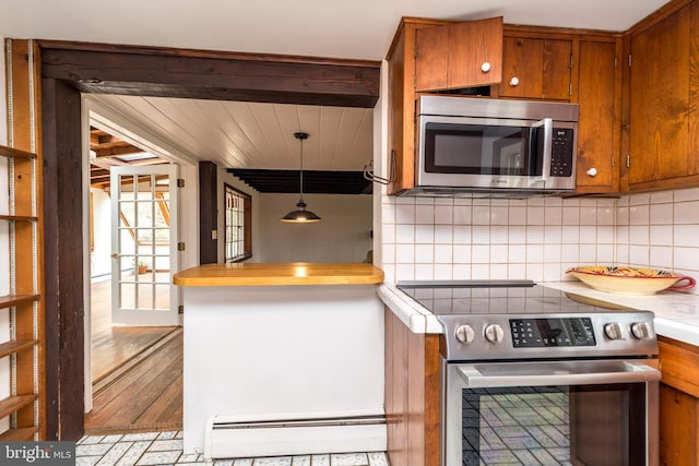 kitchen with hanging light fixtures, decorative backsplash, appliances with stainless steel finishes, a baseboard radiator, and beamed ceiling