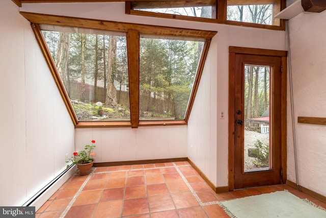 doorway to outside with light tile patterned flooring and a baseboard radiator