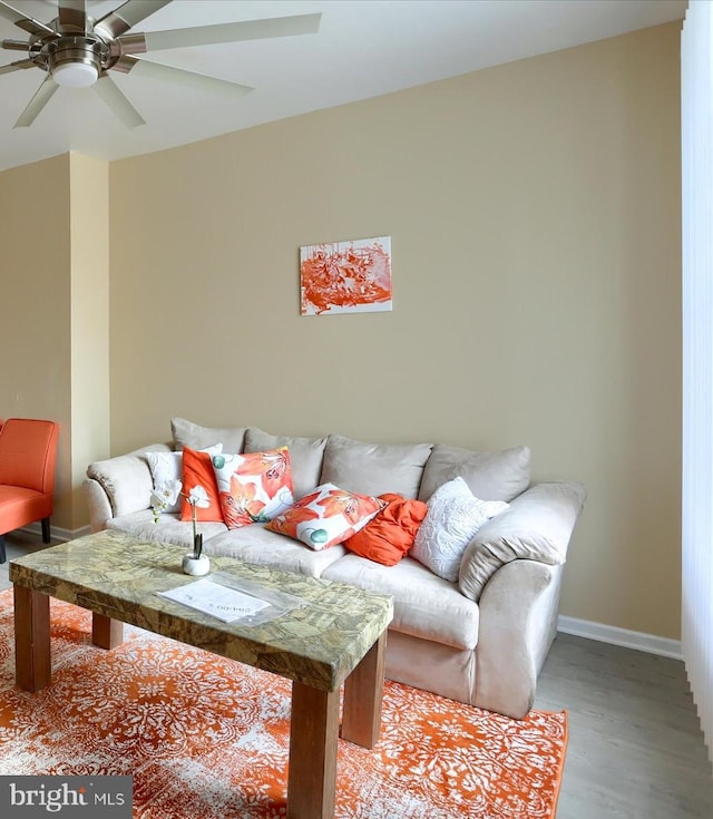 living room featuring ceiling fan and light hardwood / wood-style floors