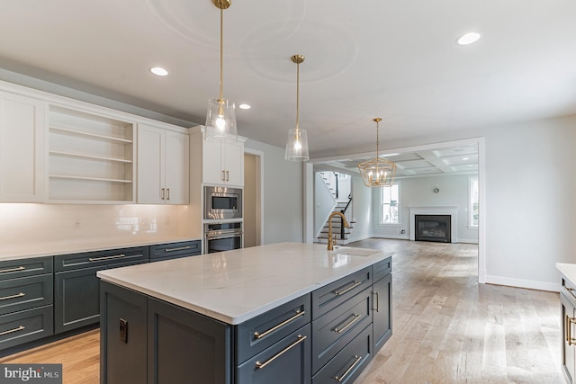 kitchen featuring light hardwood / wood-style flooring, white cabinetry, stainless steel appliances, sink, and tasteful backsplash