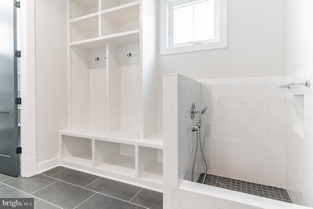 mudroom featuring dark tile flooring