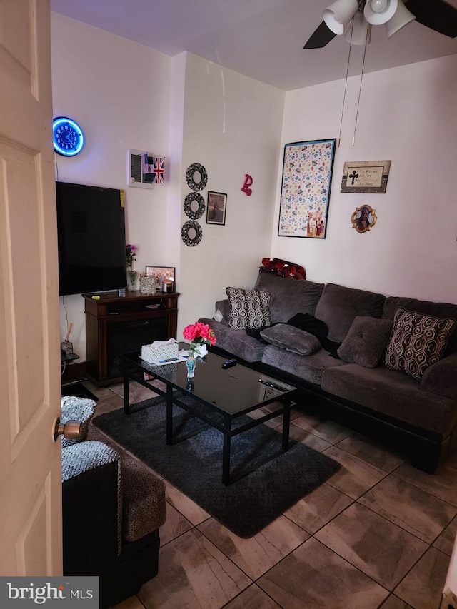 tiled living room featuring ceiling fan