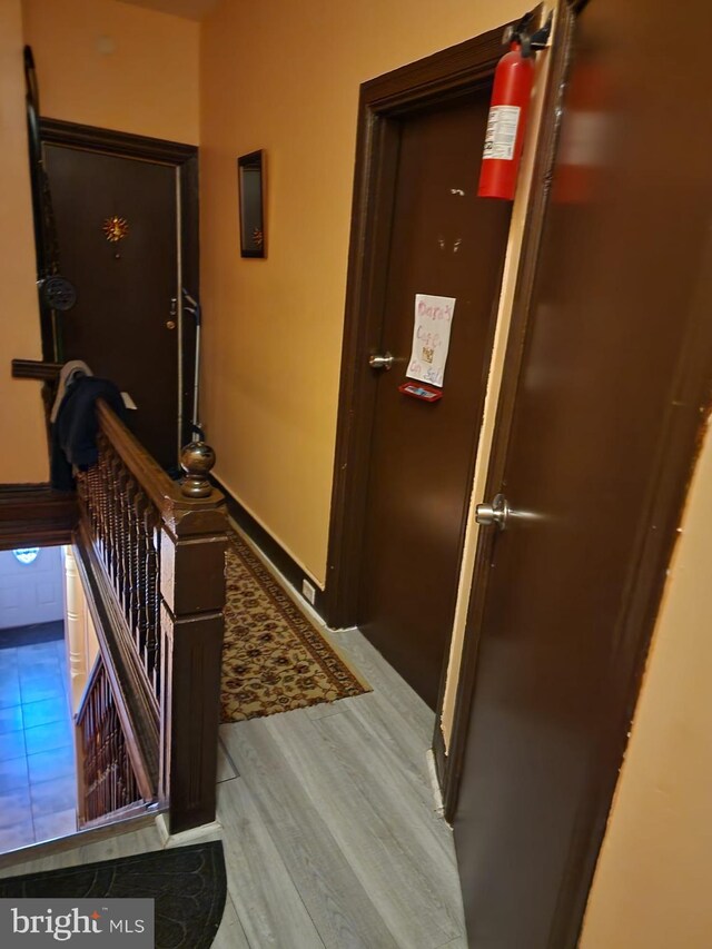 hallway with hardwood / wood-style flooring