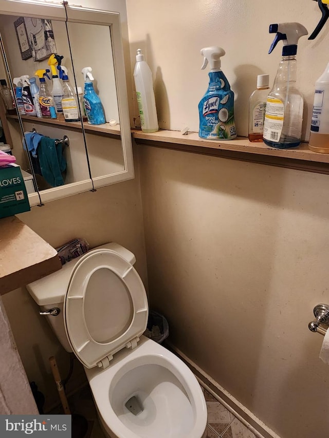 bathroom featuring tile floors and toilet