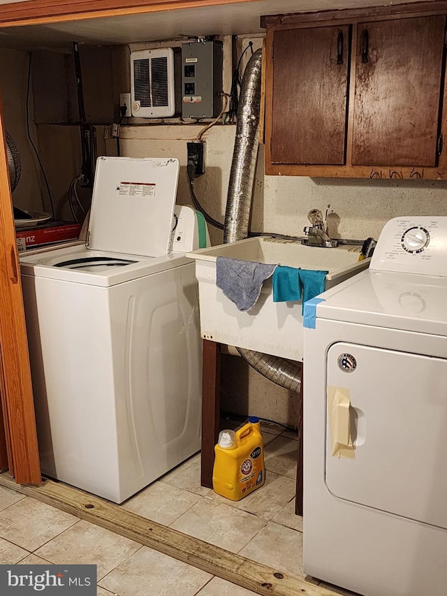 laundry area featuring hookup for an electric dryer, light tile flooring, independent washer and dryer, and cabinets