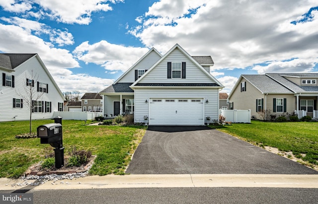 view of front of property with a garage and a front lawn