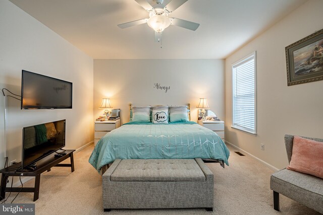 bedroom with light carpet and ceiling fan