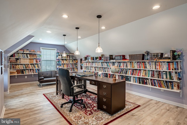 home office featuring vaulted ceiling and light wood-type flooring