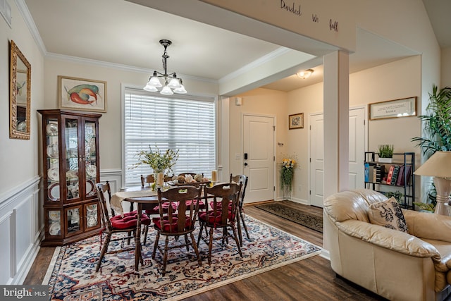 dining room with a chandelier, crown molding, and dark hardwood / wood-style floors