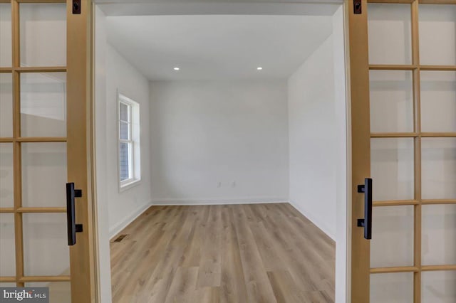 empty room with light hardwood / wood-style floors