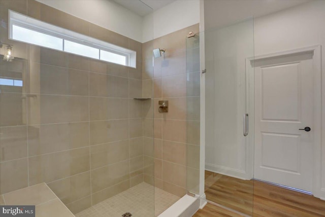 bathroom featuring walk in shower and wood-type flooring