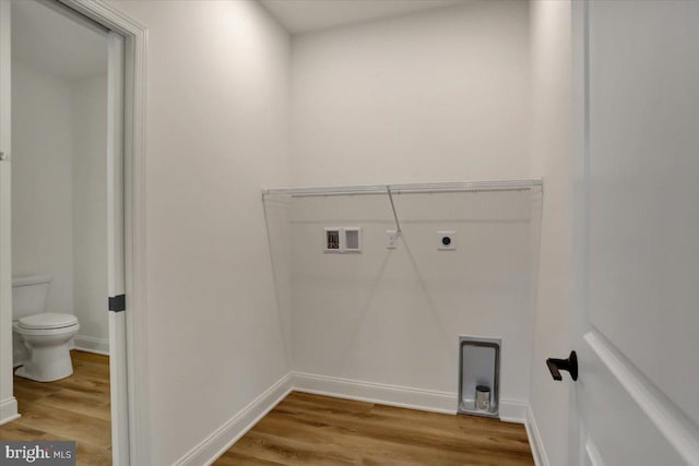 laundry room with electric dryer hookup, light hardwood / wood-style floors, and washer hookup