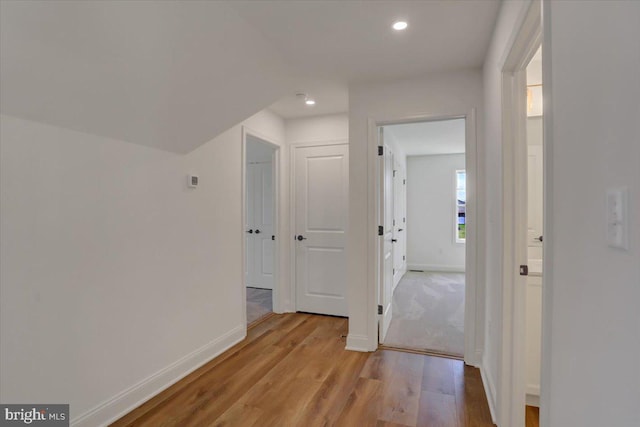 corridor with light hardwood / wood-style floors