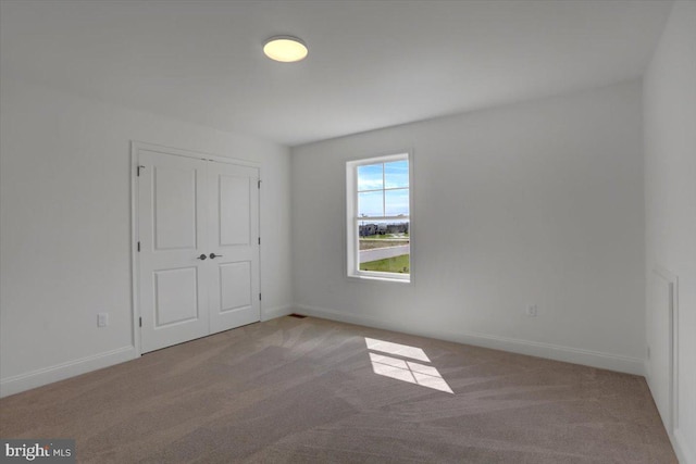 empty room featuring light carpet