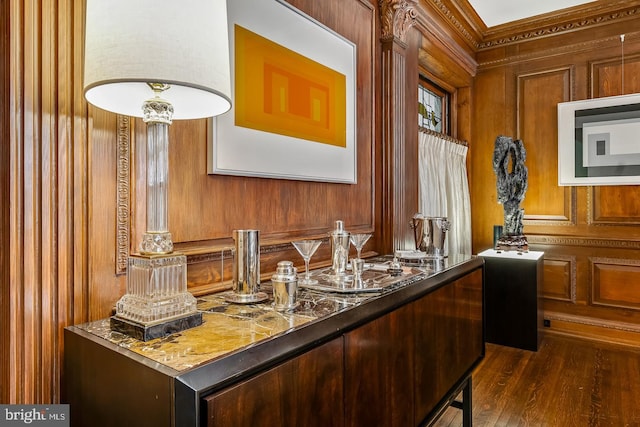 interior space featuring dark stone countertops, dark hardwood / wood-style flooring, and wood walls