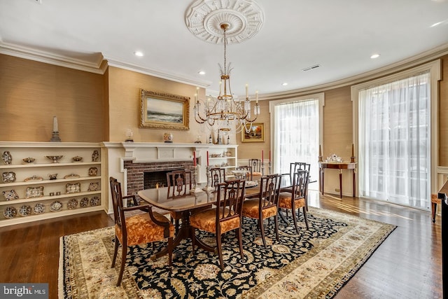 dining area with dark hardwood / wood-style floors, ornamental molding, and a fireplace