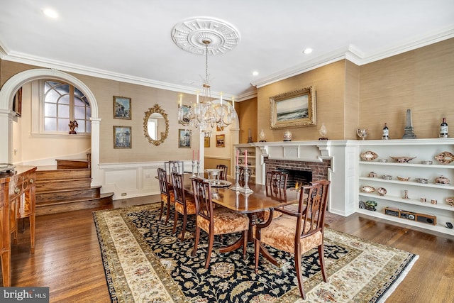 dining room featuring crown molding, dark hardwood / wood-style flooring, and a fireplace