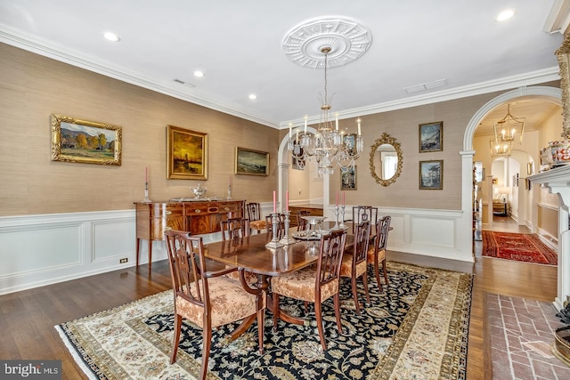 dining room featuring ornamental molding, a chandelier, and dark wood-type flooring