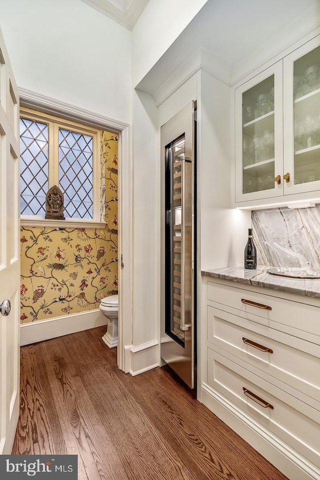 bathroom featuring vanity, toilet, and hardwood / wood-style flooring