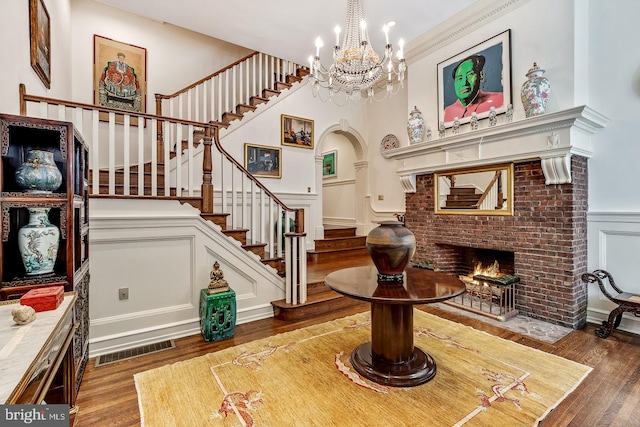 interior space featuring a fireplace, a chandelier, and hardwood / wood-style floors