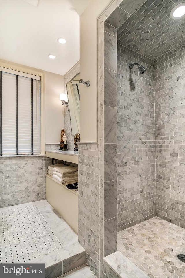 bathroom featuring tile flooring and a tile shower