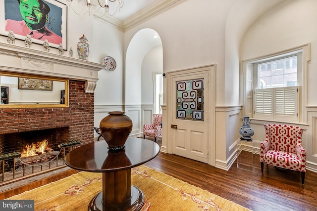 sitting room featuring dark hardwood / wood-style flooring, a fireplace, and crown molding