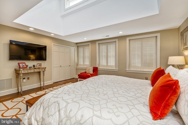 bedroom with multiple windows and light wood-type flooring