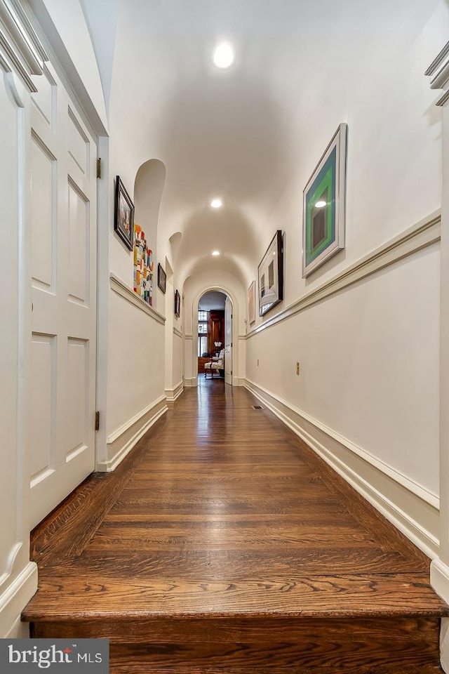 corridor with dark hardwood / wood-style floors