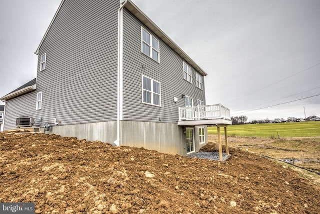 view of home's exterior with a deck and central AC unit