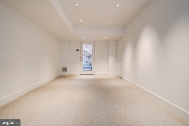 unfurnished room featuring light colored carpet