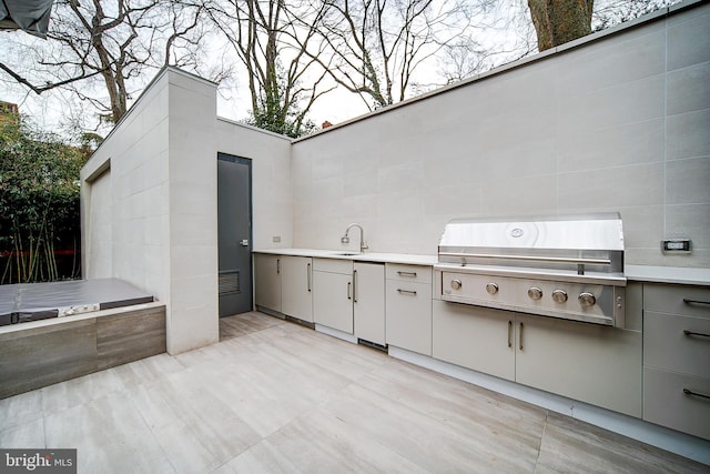 view of patio featuring sink, an outdoor kitchen, and a grill