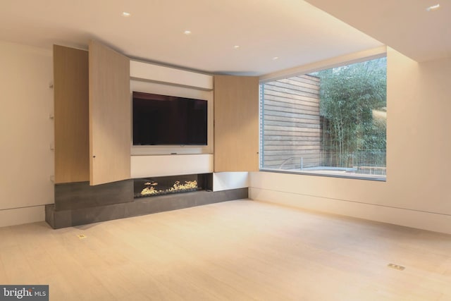 unfurnished living room featuring hardwood / wood-style floors