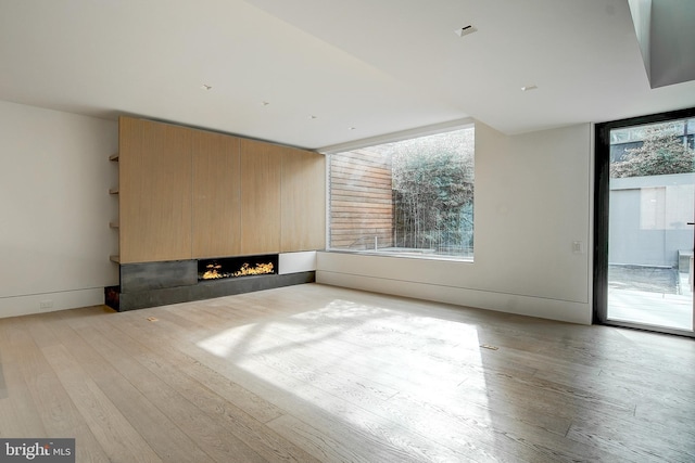 unfurnished living room with light hardwood / wood-style flooring