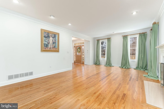 empty room with light hardwood / wood-style flooring and ornamental molding