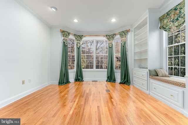 interior space featuring crown molding and light hardwood / wood-style floors