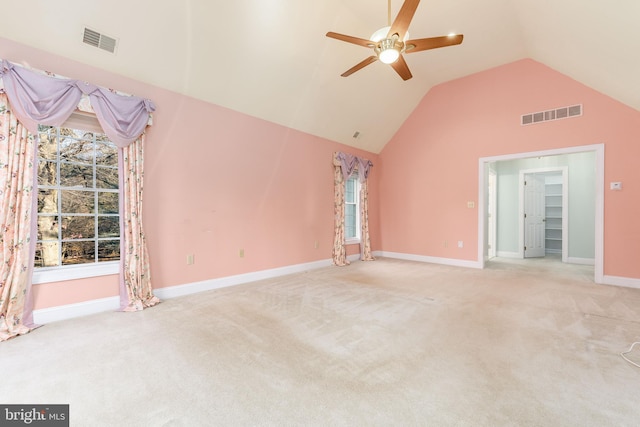 unfurnished living room with light carpet, ceiling fan, and vaulted ceiling