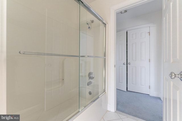 bathroom with shower / bath combination with glass door and tile patterned floors