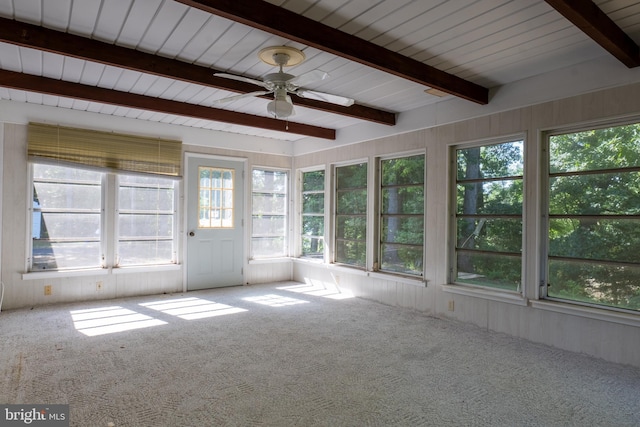 unfurnished sunroom featuring beamed ceiling and ceiling fan