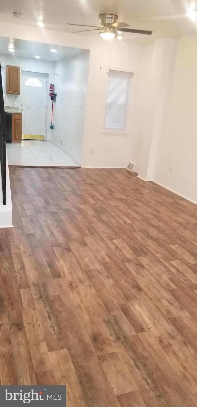 spare room with ceiling fan and light tile floors