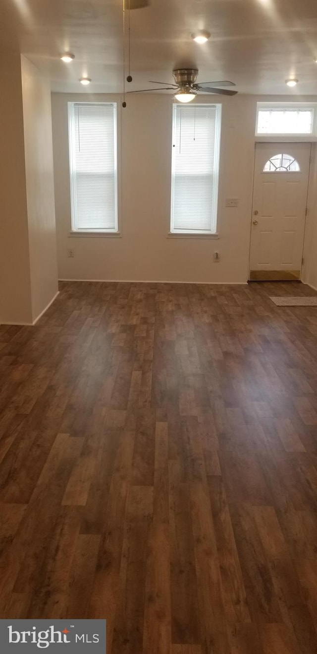 unfurnished room with ceiling fan and dark hardwood / wood-style floors