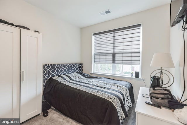 bedroom featuring light colored carpet