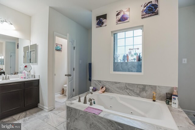 bathroom featuring vanity, tile floors, and toilet