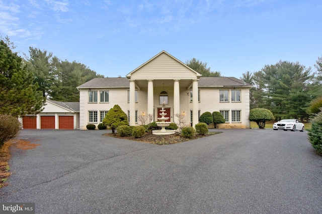 neoclassical home with a garage