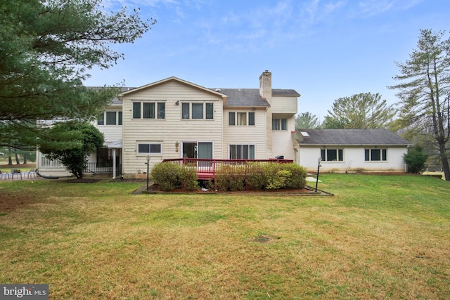 back of house featuring a deck and a yard