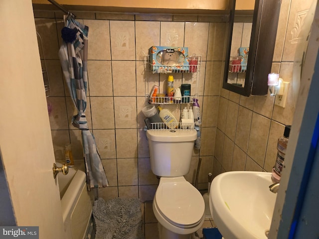 full bathroom featuring shower / bath combination with curtain, toilet, tile walls, and sink