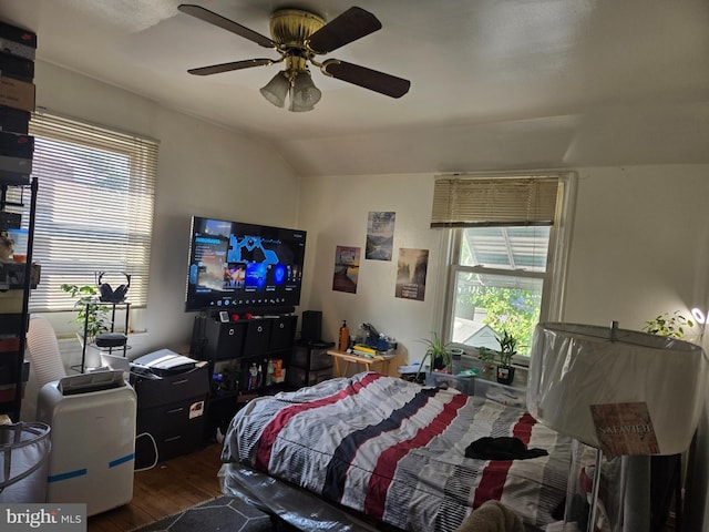 bedroom featuring multiple windows, ceiling fan, wood-type flooring, and vaulted ceiling