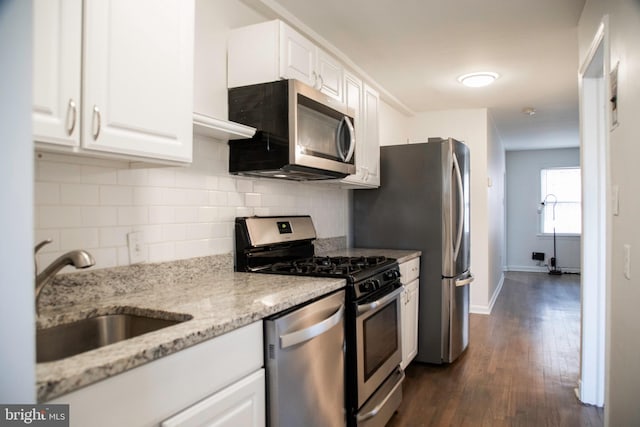 kitchen featuring dark hardwood / wood-style flooring, white cabinets, and stainless steel appliances