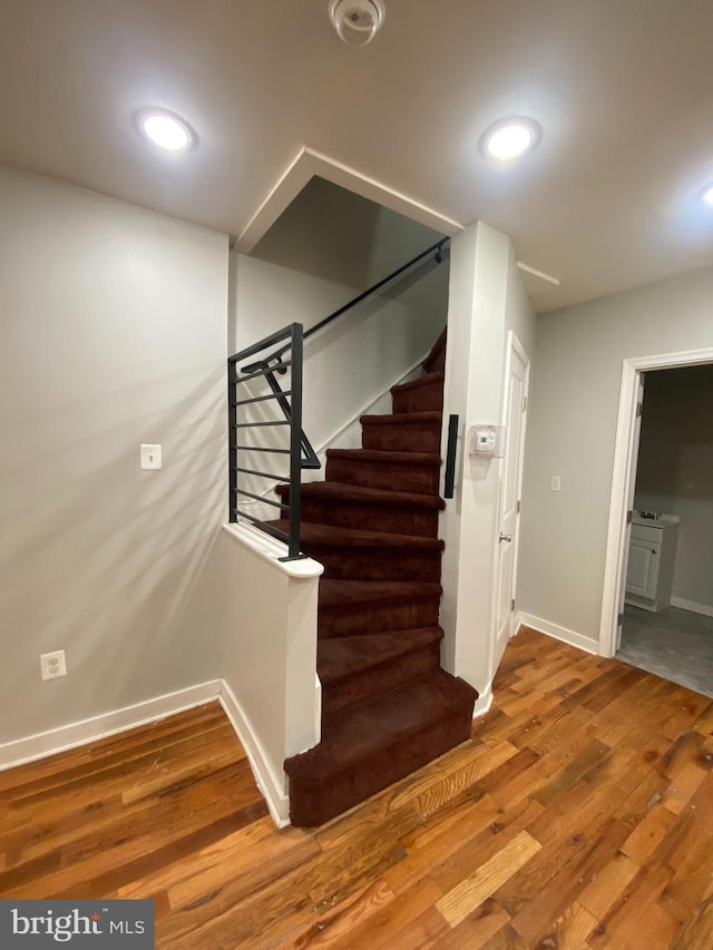 staircase with wood-type flooring